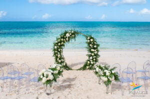 circle wedding arch with greenery and white flowers