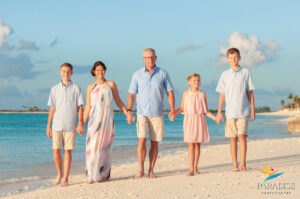 family walking holding hands on the beach