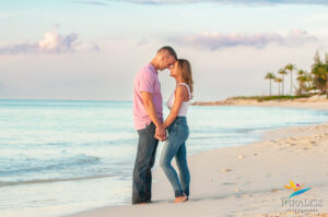 couple on the beach foreheads touching
