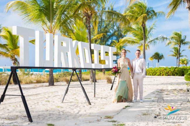 club med turkoise sign with wedding couple