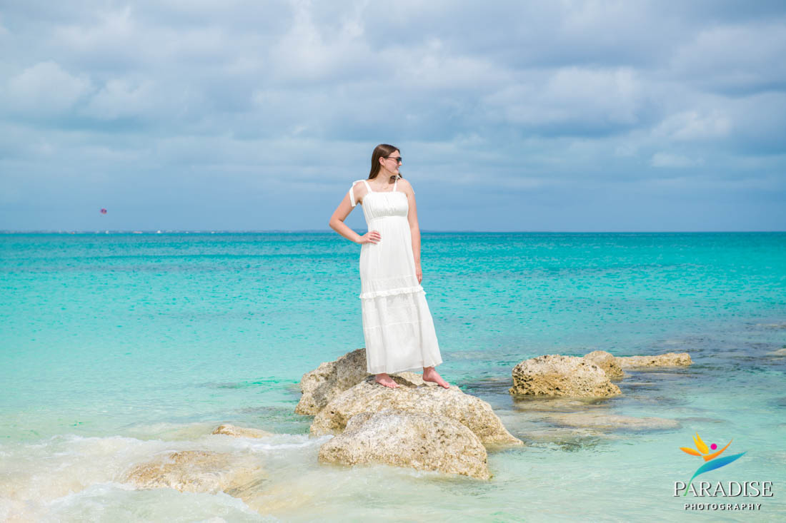 standing on rocks in the ocean