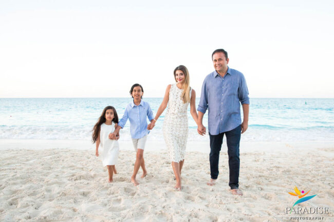 holding hands walking up the beach