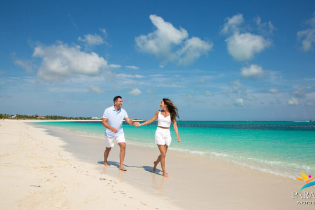 couple hand in hand on the beach