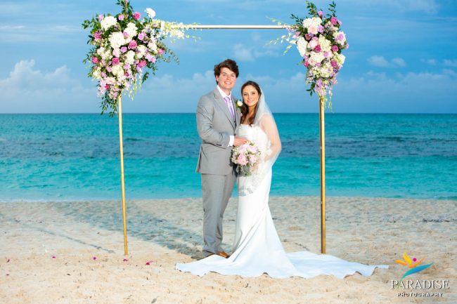 01-Wymara-Resort-Wedding-Turks-and-Caicos wedding couple under beach arch