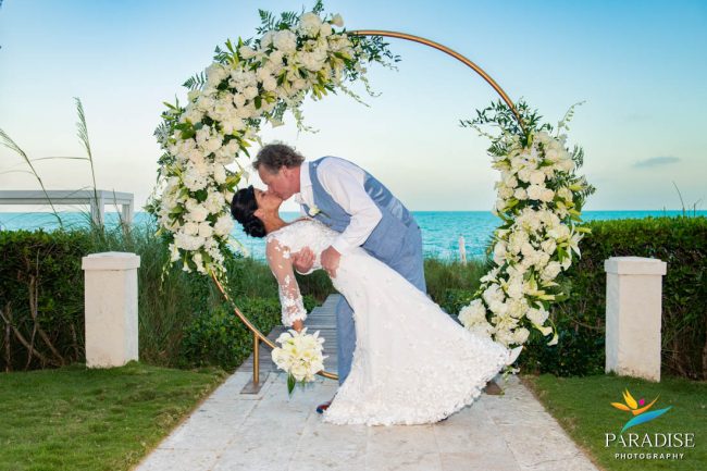 12-Shore-Club-Wedding-in-Turks-and-Caicos dip kiss at wedding arch