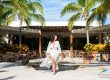 girl walking around resort in white dress