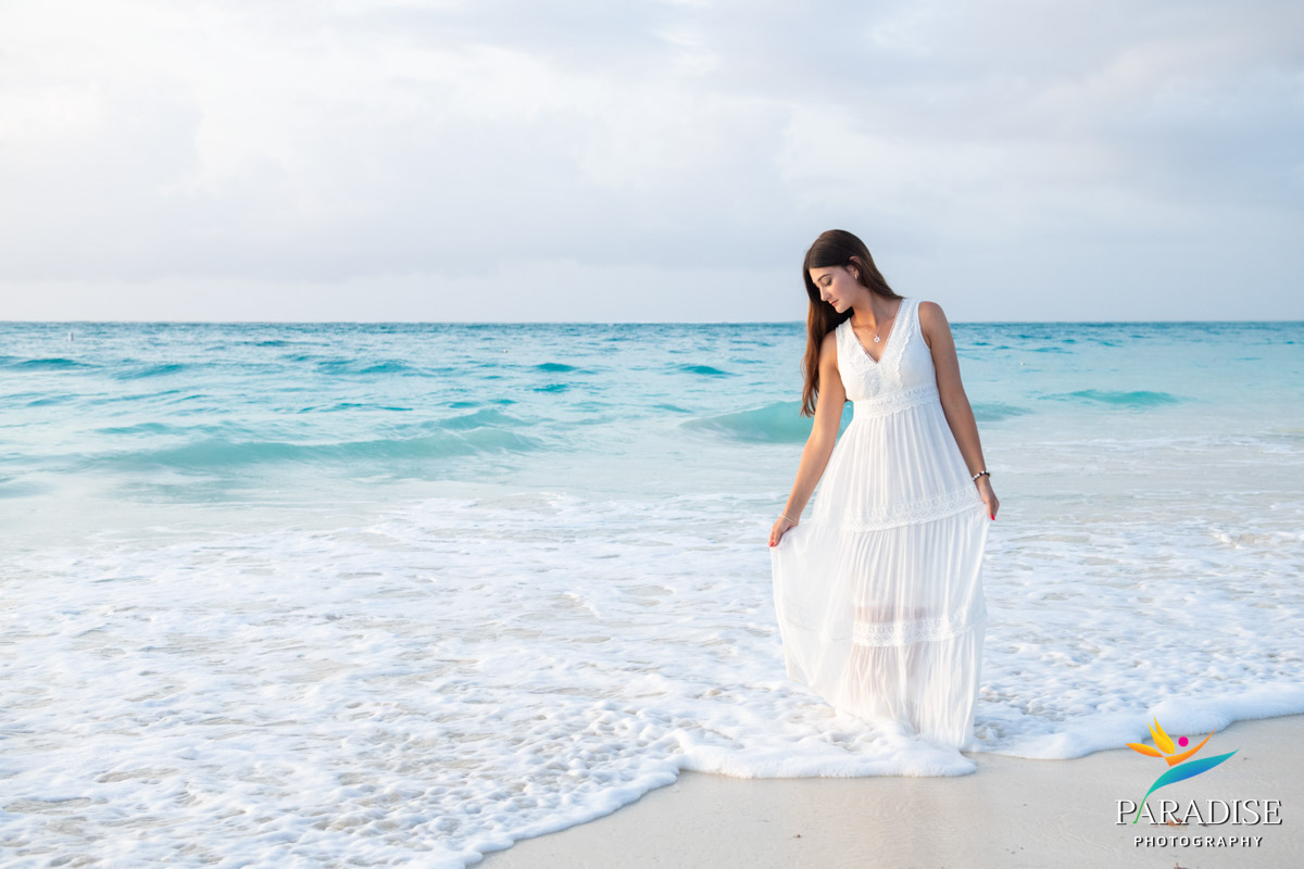 women walking in water on beach