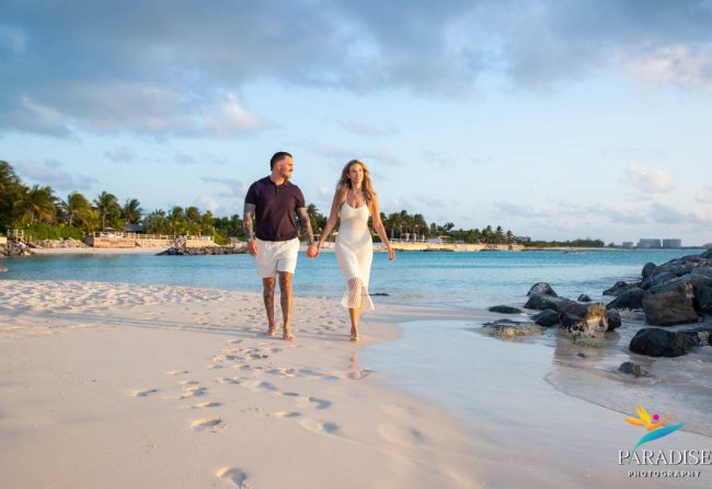 Couple enjoying a moment together on the sandy shore.