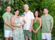 Large family group portrait wearing green and white during a villa photoshoot in Turks and Caicos.