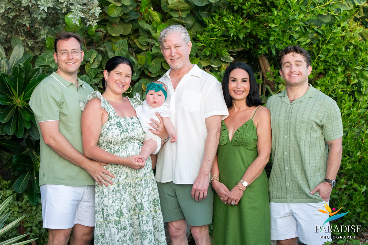 Large family group portrait wearing green and white during a villa photoshoot in Turks and Caicos.