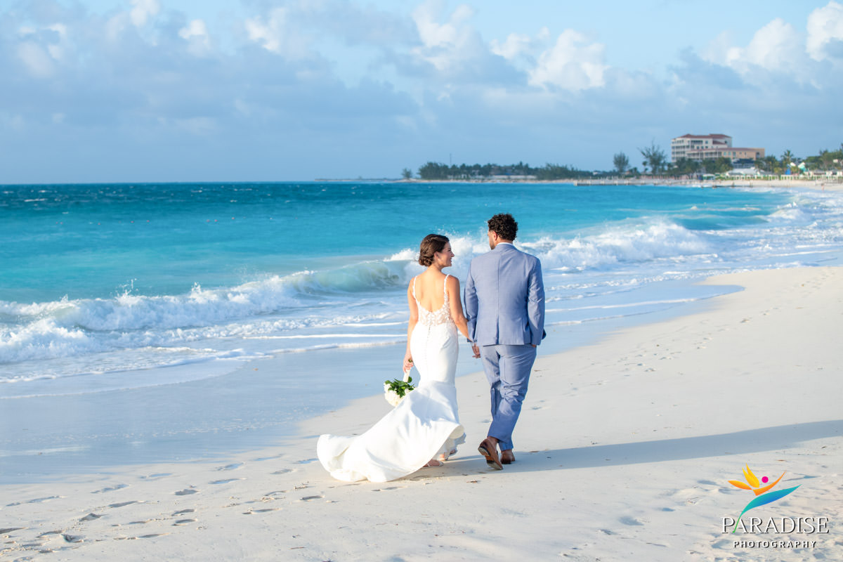 bride and groom walking on beach