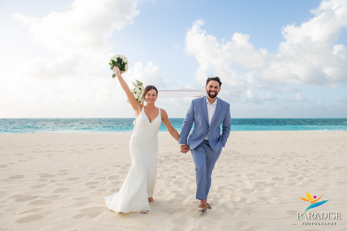 bride in sand holding bouquet