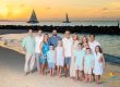 the whole family on the beach as the sun deeps down over the sea