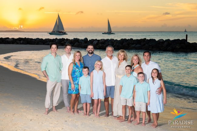 sunset-family-photo- the whole family on the beach as the sun deeps down over the sea