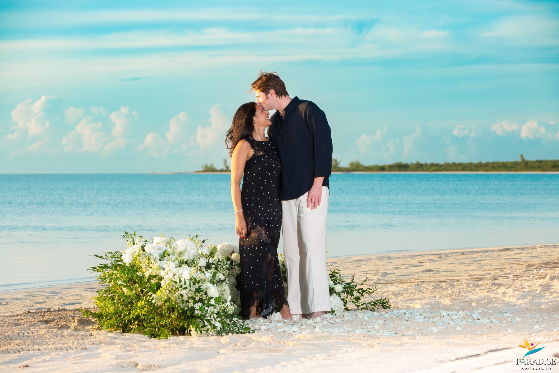 A beautiful family couple sharing a romantic walk along the ocean shoreline