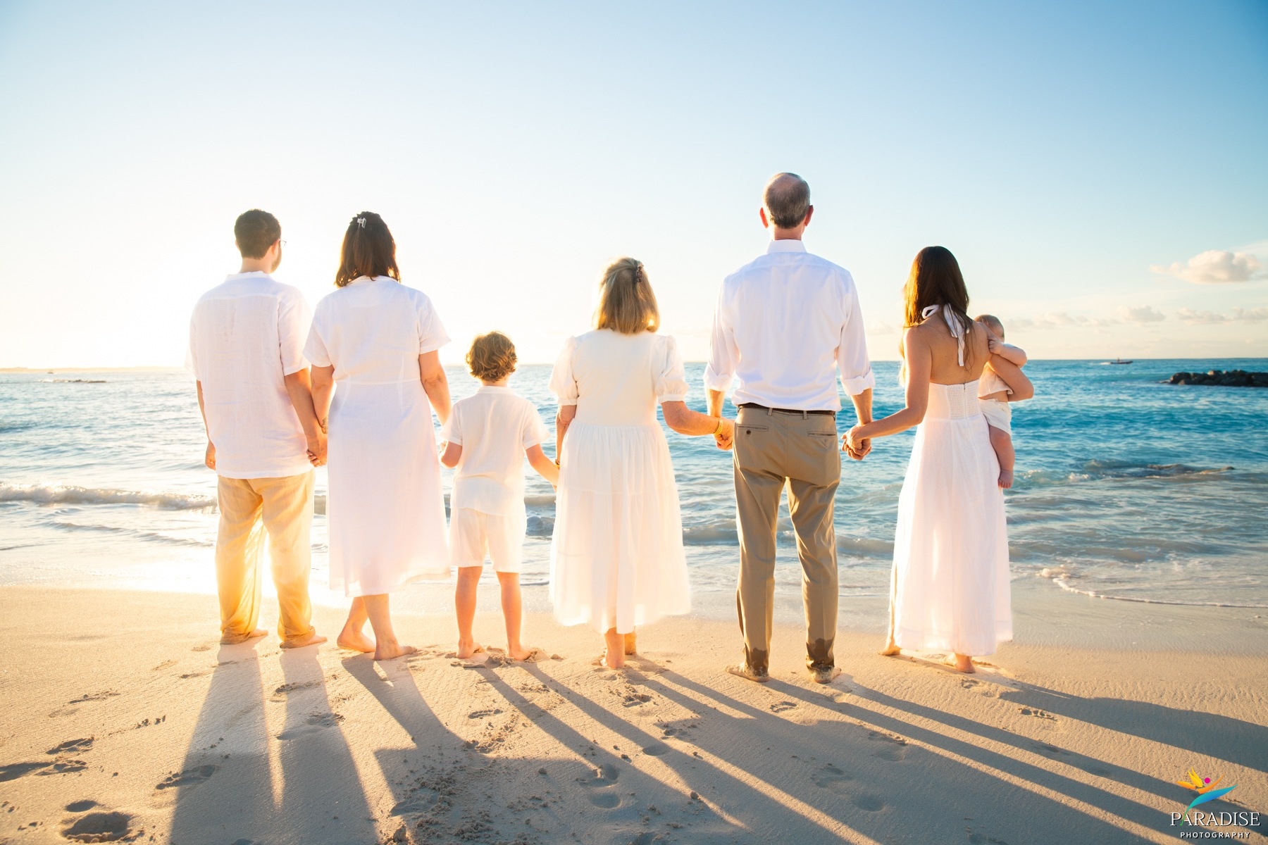A beautiful family couple strolling hand in hand along a beach pier waterfront