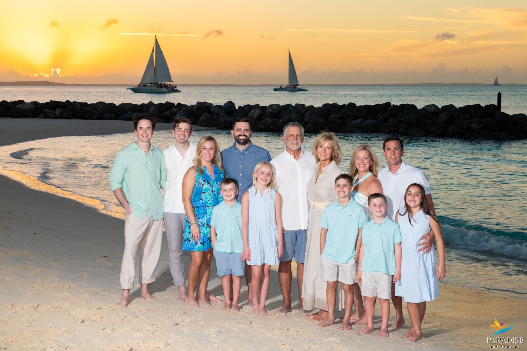 A beautiful family with children running and playing joyfully along the beach waves