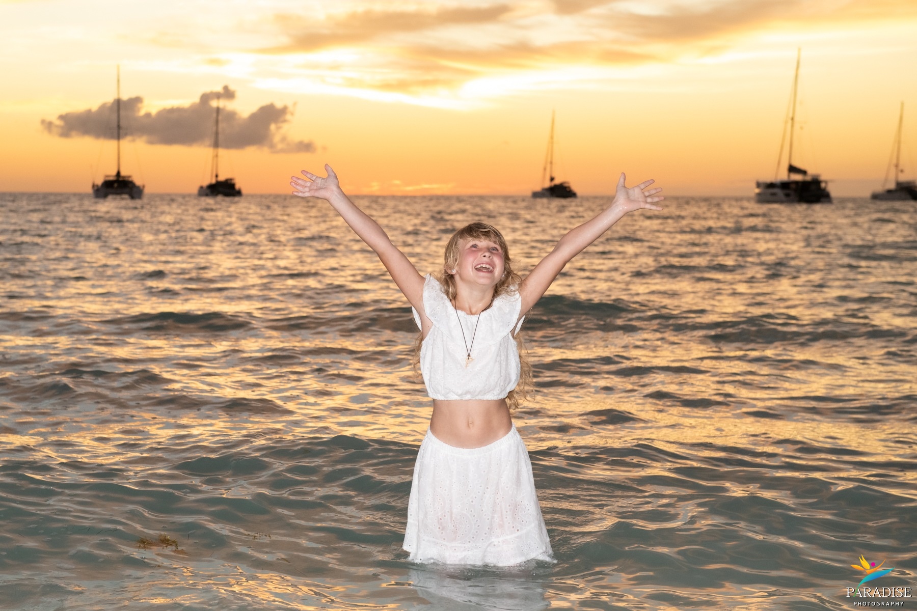 A beautiful family silhouette embracing by the ocean during a stunning golden hour sunset