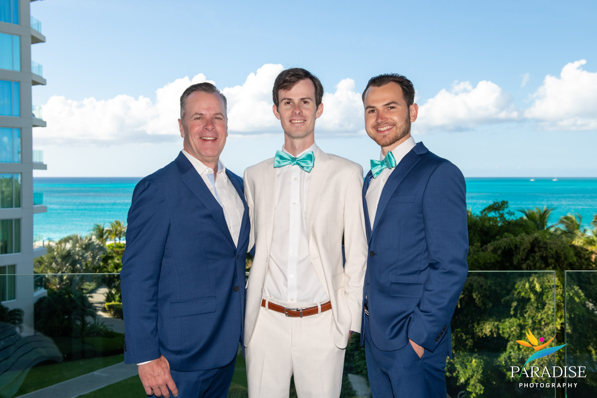Groom and groomsmen in navy suits on the beach at Ritz-Carlton Turks and Caicos wedding