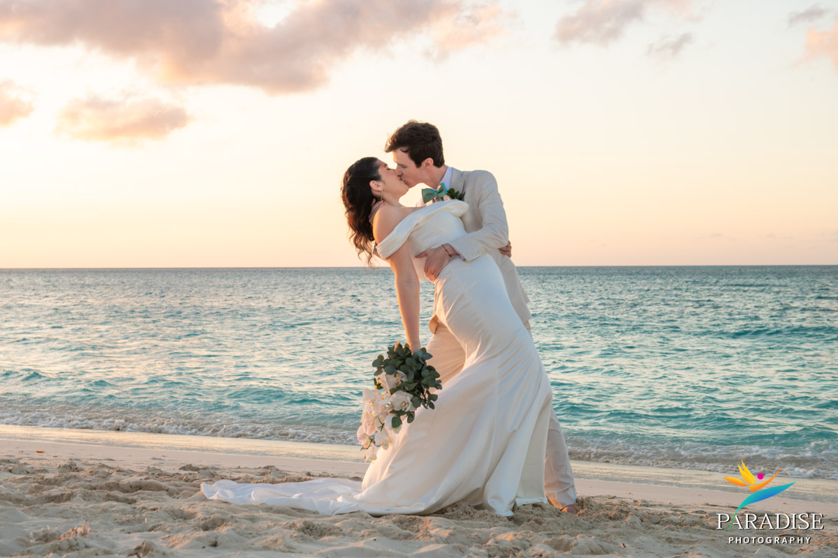 Groom dips bride for a kiss on the beach at sunset, Ritz-Carlton Turks and Caicos wedding