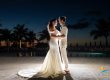 Bride and groom embrace at night by the pool during their Ritz-Carlton Turks and Caicos wedding